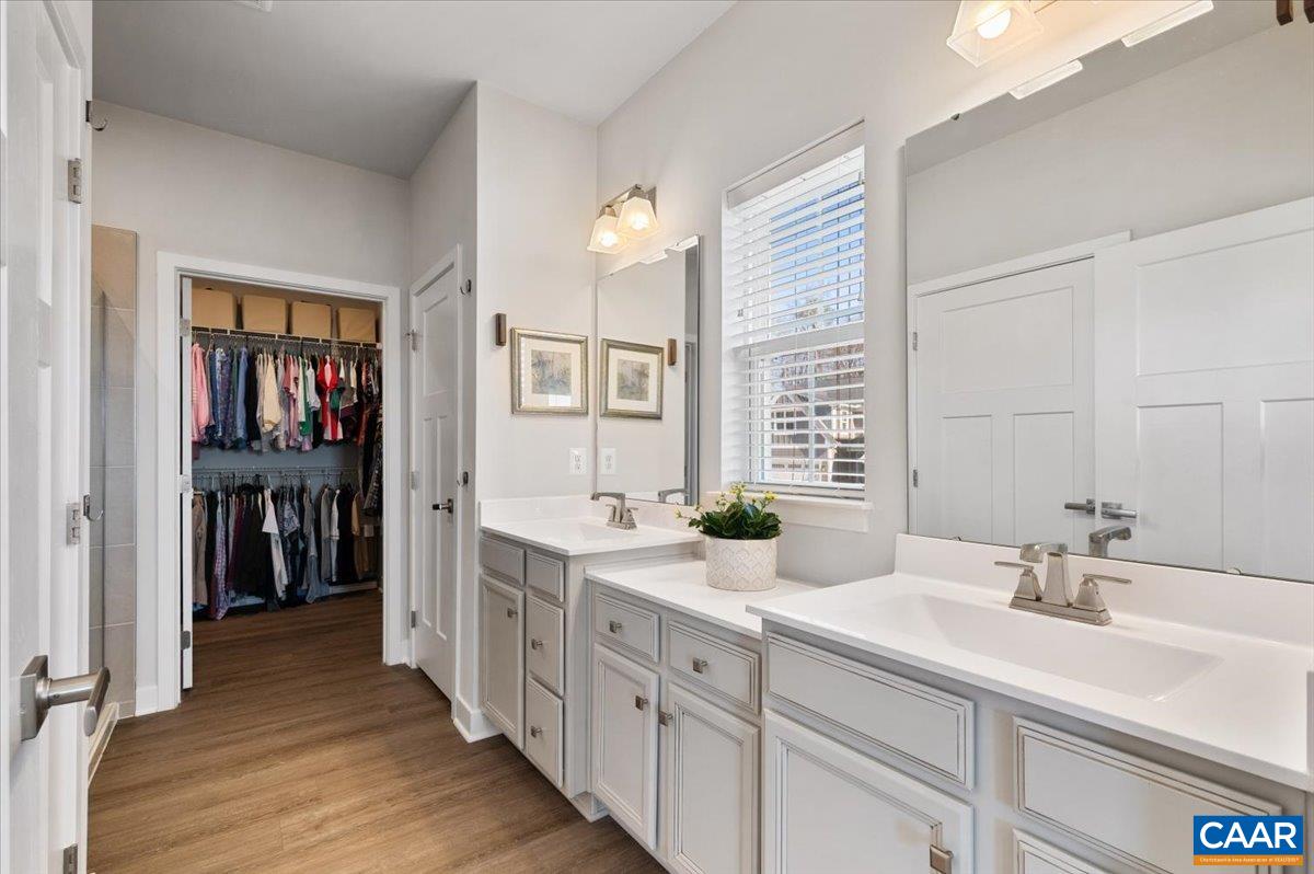 832 Swede Street Charlottesville, VA 22901 - Photo 20 of 57 a spacious bathroom with a double vanity sink and a mirror
