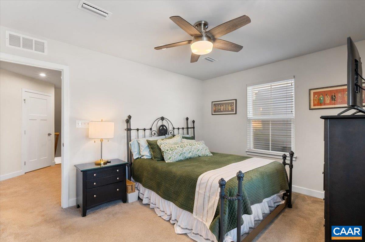 832 Swede Street Charlottesville, VA 22901 - Photo 27 of 57 a bedroom with a bed and a chandelier