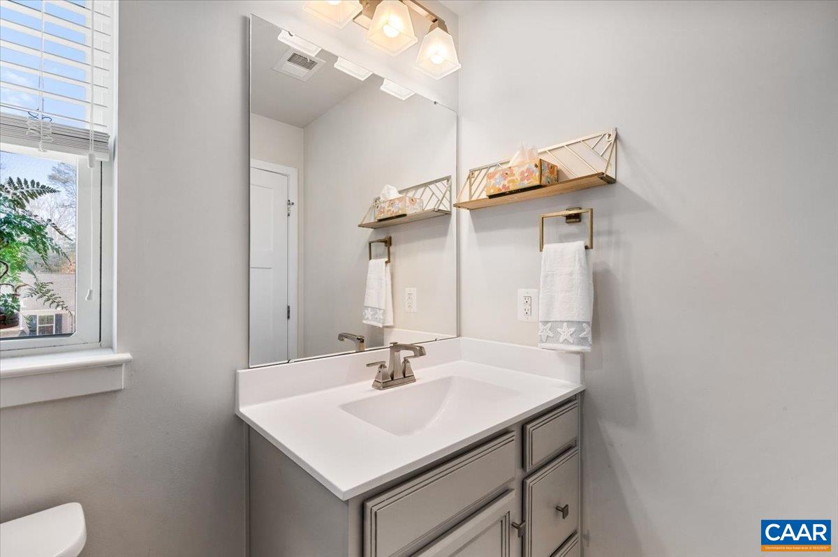 832 Swede Street Charlottesville, VA 22901 - Photo 34 of 57 a bathroom with a sink a toilet and a mirror