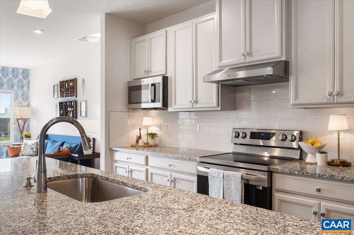 832 Swede Street Charlottesville, VA 22901 - Photo 8 of 57 a kitchen with stainless steel appliances granite countertop a sink stove and refrigerator