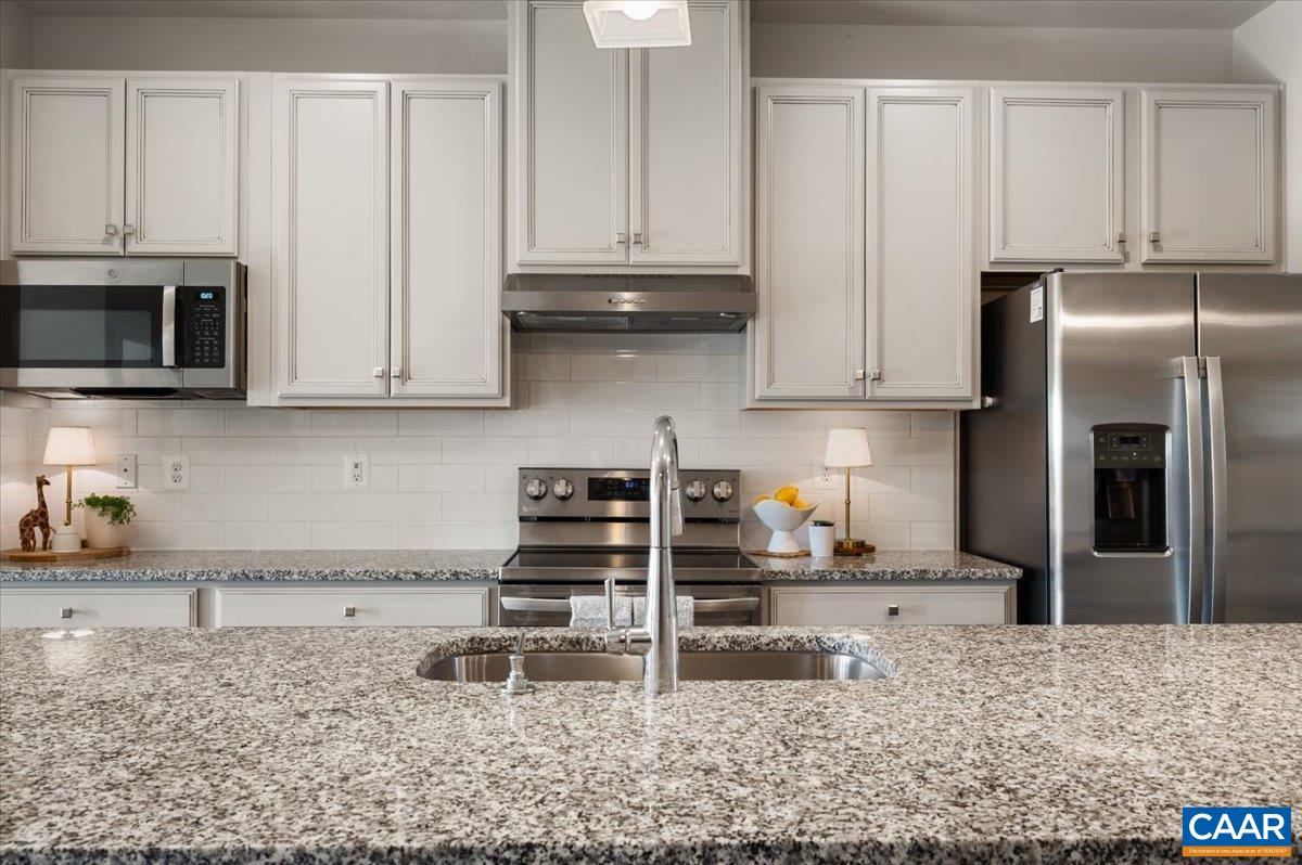 832 Swede Street Charlottesville, VA 22901 - Photo 9 of 57 a kitchen with stainless steel appliances granite countertop a stove a microwave and refrigerator