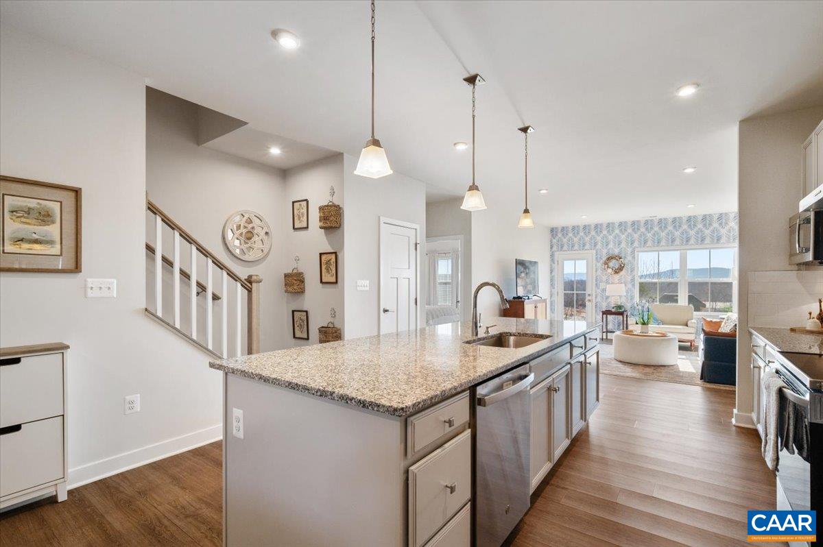 832 Swede Street Charlottesville, VA 22901 - Photo 10 of 57 a kitchen with granite countertop a sink a counter top space and stainless steel appliances