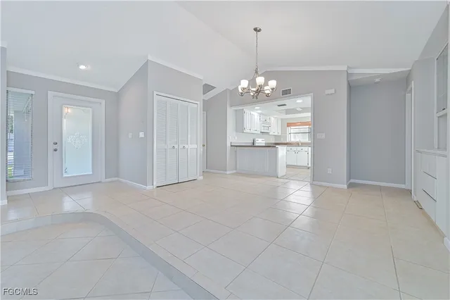 a view of a kitchen with a sink and chandelier
