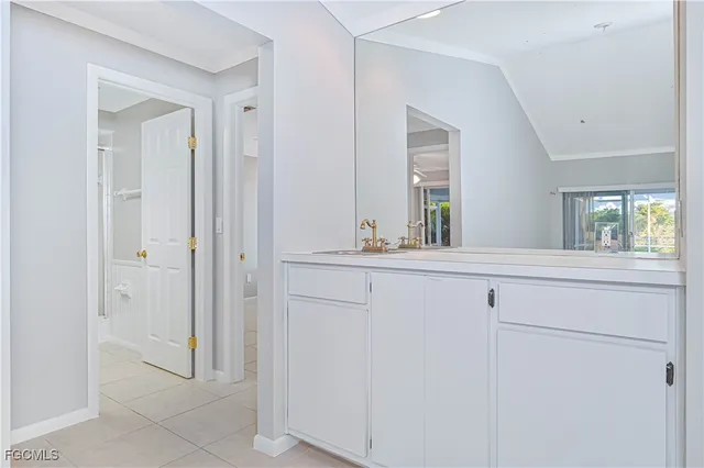 a view of bathroom with closet and mirror