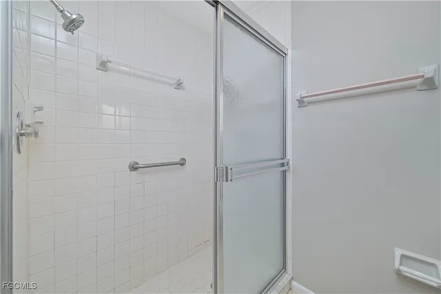 a bathroom with a glass shower door