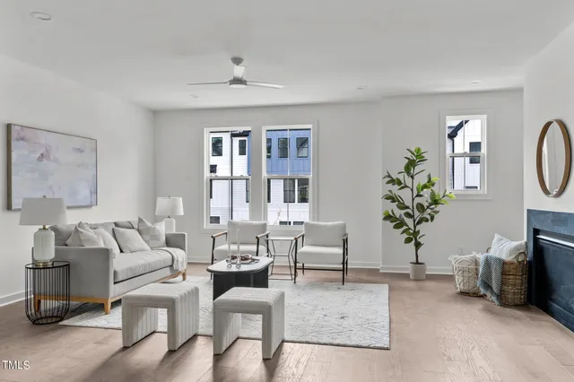 a living room with furniture a potted plant and a window