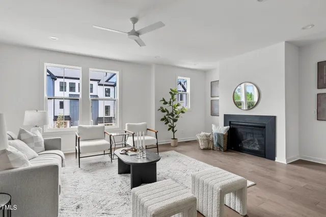 a living room with furniture a fireplace and a window