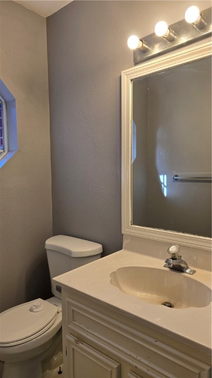 5026 Rasputin Court Corpus Christi, TX 78413 - Photo 17 of 40 a bathroom with a sink a toilet and mirror