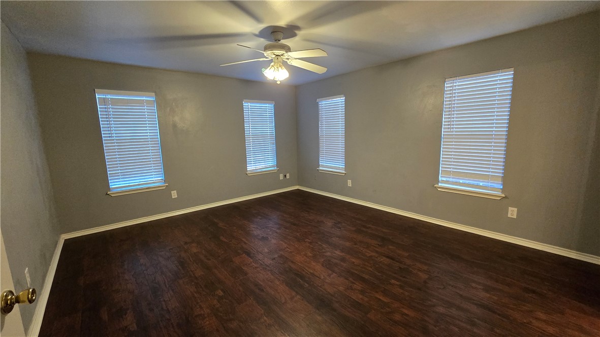 5026 Rasputin Court Corpus Christi, TX 78413 - Photo 19 of 40 a view of an empty room with wooden floor and a window