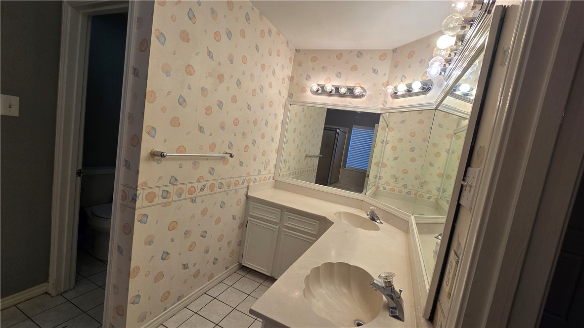 5026 Rasputin Court Corpus Christi, TX 78413 - Photo 22 of 40 a bathroom with a sink and a mirror