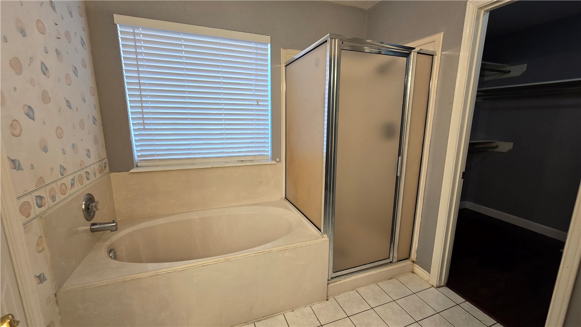 5026 Rasputin Court Corpus Christi, TX 78413 - Photo 23 of 40 a bathroom with a bathtub and a shower