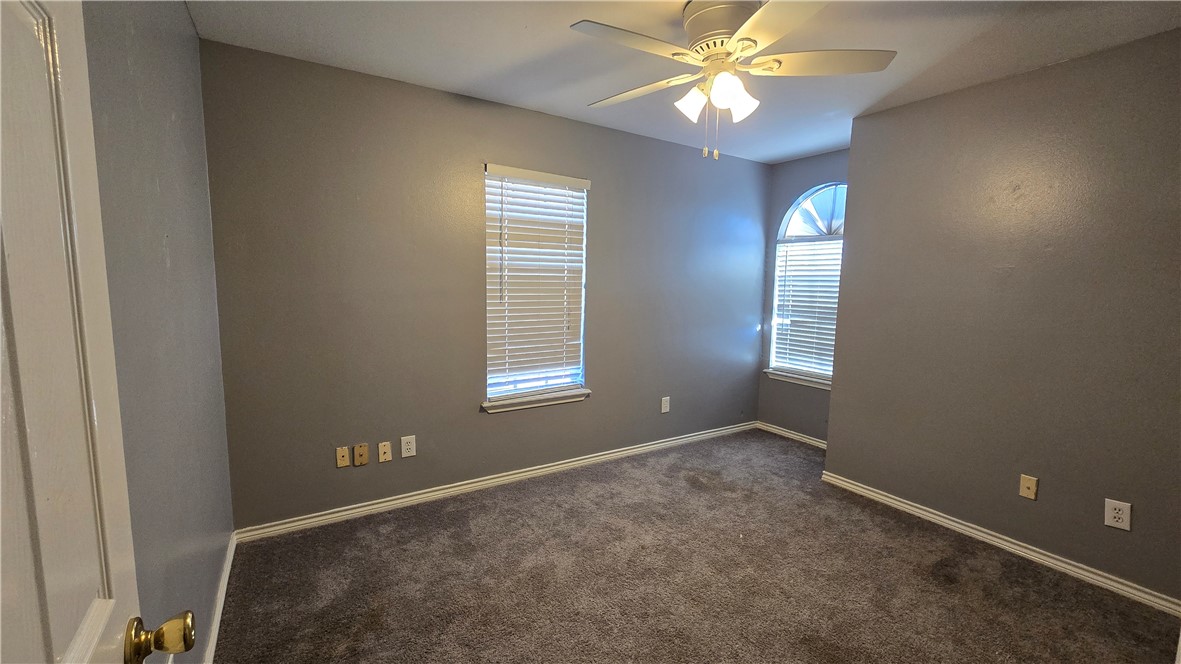 5026 Rasputin Court Corpus Christi, TX 78413 - Photo 31 of 40 a view of an empty room with window and chandelier fan