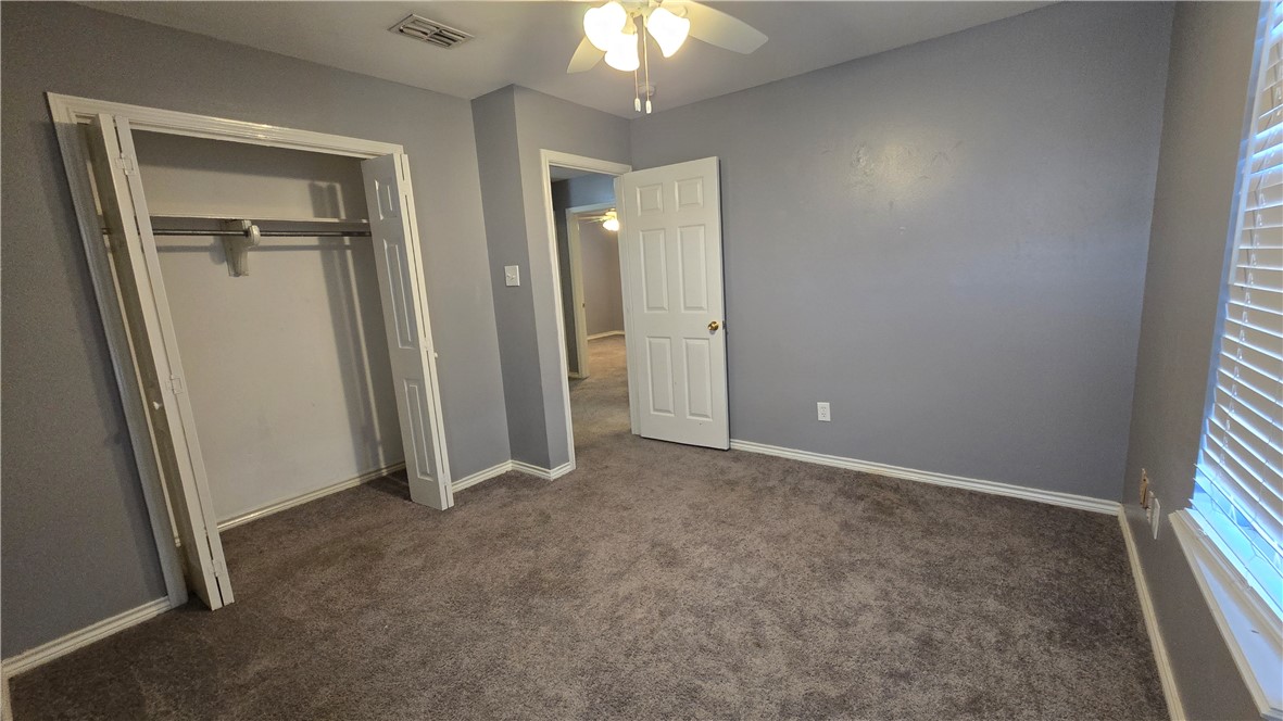 5026 Rasputin Court Corpus Christi, TX 78413 - Photo 32 of 40 an empty room with windows and closet