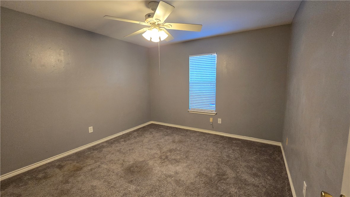 5026 Rasputin Court Corpus Christi, TX 78413 - Photo 34 of 40 an empty room with windows and fan