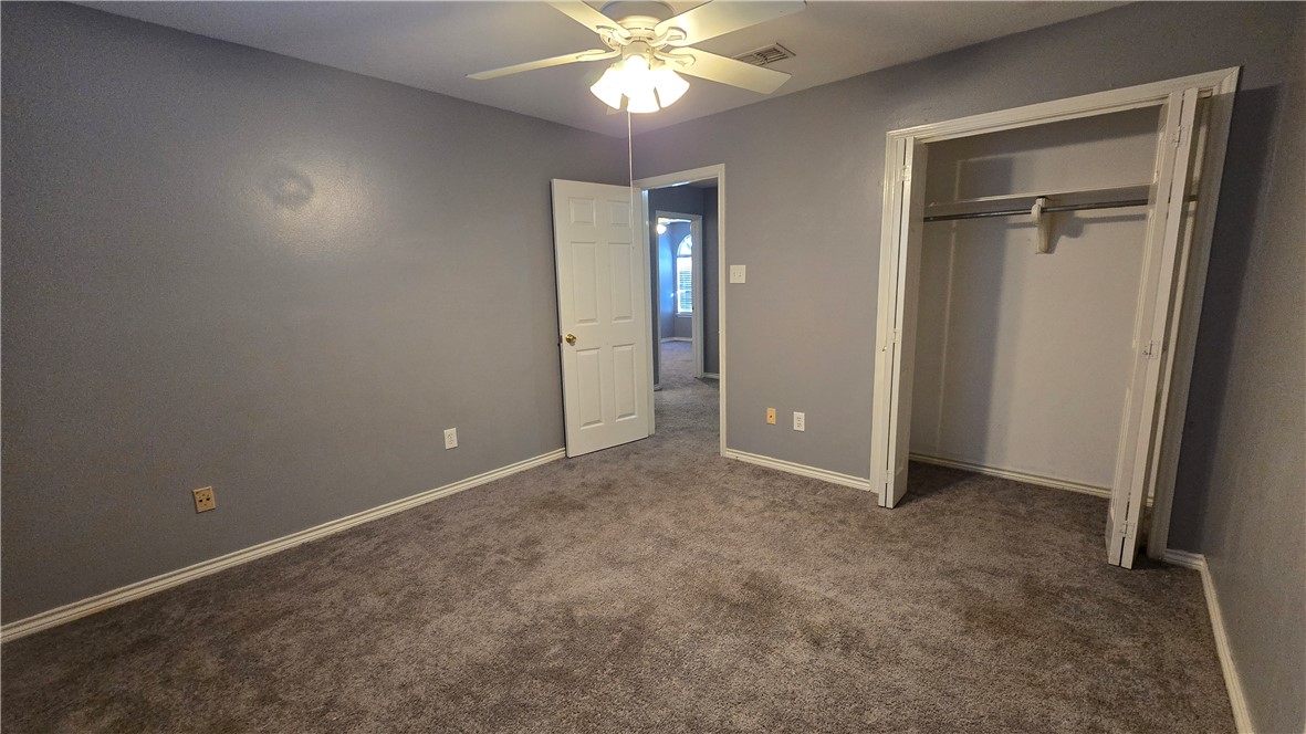 5026 Rasputin Court Corpus Christi, TX 78413 - Photo 35 of 40 an empty room with closet and a chandelier fan