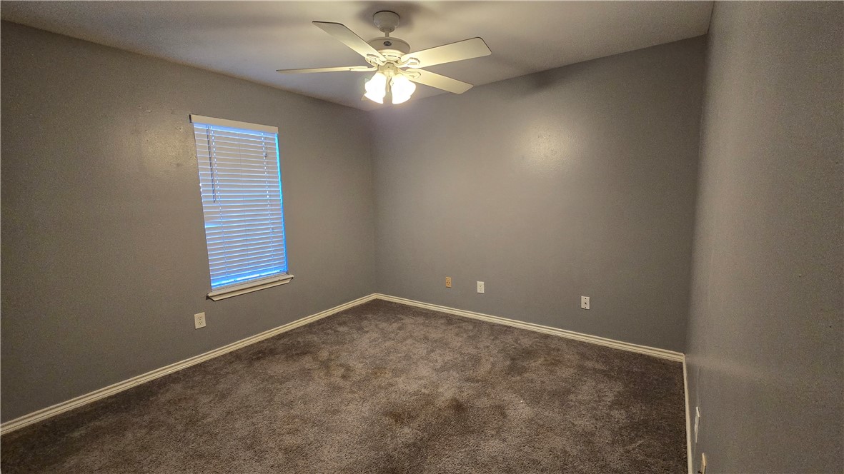 5026 Rasputin Court Corpus Christi, TX 78413 - Photo 36 of 40 an empty room with windows and fan