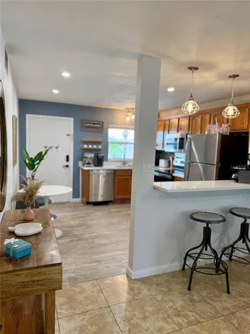a kitchen with stainless steel appliances kitchen island granite countertop a sink and a counter top space