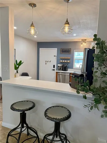 a kitchen with a table and chairs in it