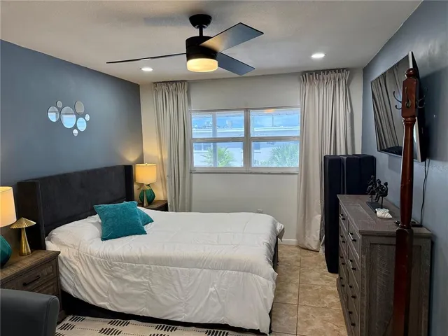 a bedroom with a bed and a television