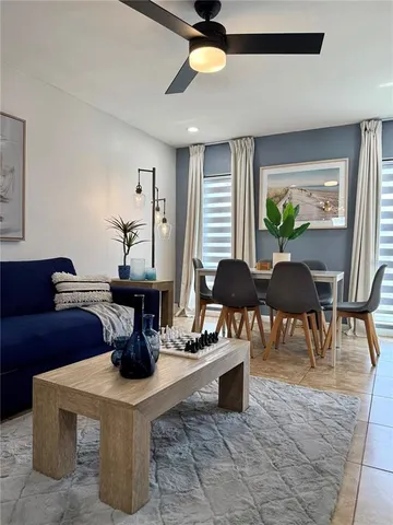 a living room with fireplace furniture and a potted plant