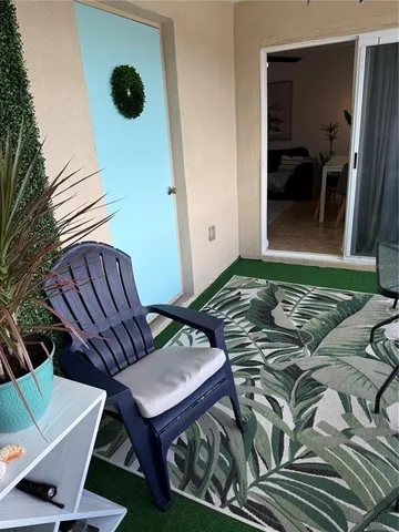 a view of a backyard of a house with wooden floor and outdoor seating