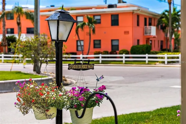 a view of a pathway of a patio with wooden fence and floor