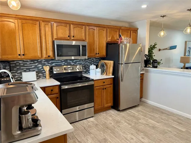 a kitchen with a sink stove and refrigerator
