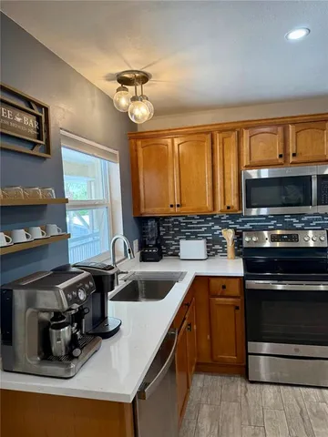 a kitchen with a sink appliances and cabinets