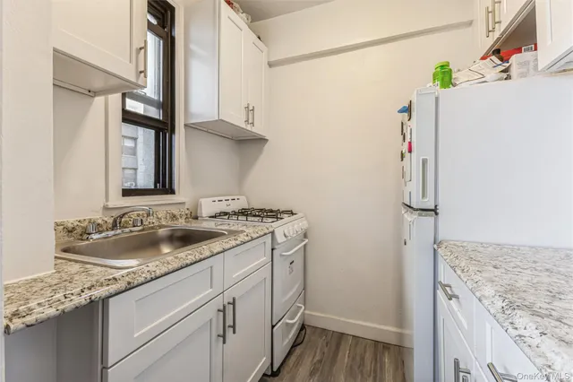 a kitchen with a stove a refrigerator and a sink
