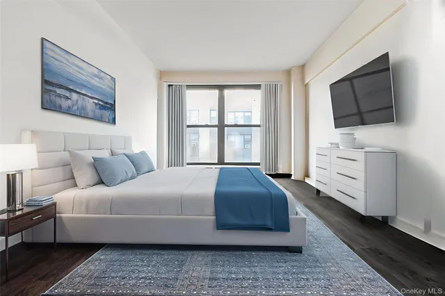 a bedroom with a bed and flat screen tv