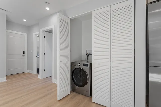 a view of a hallway with washer and dryer