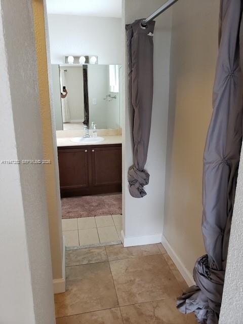 445 Southwest 11th Street, Unit 404 Miami, FL 33130 - Photo 11 of 13 a bathroom with a sink a mirror and shower