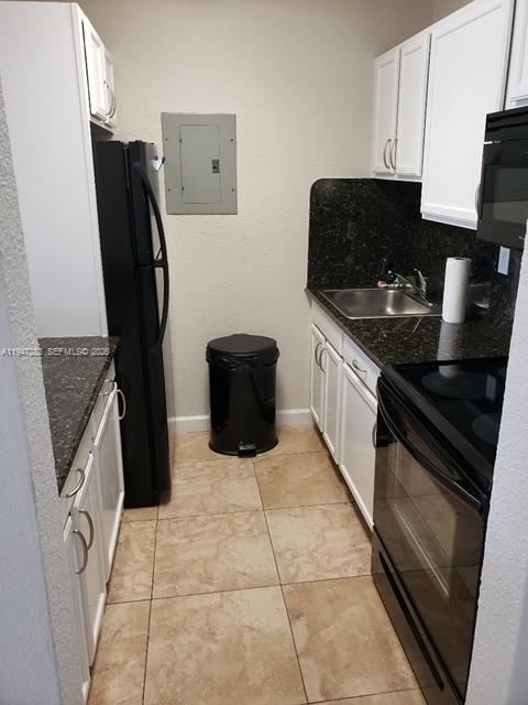 445 Southwest 11th Street, Unit 404 Miami, FL 33130 - Photo 2 of 13 a kitchen with a sink appliances and cabinets