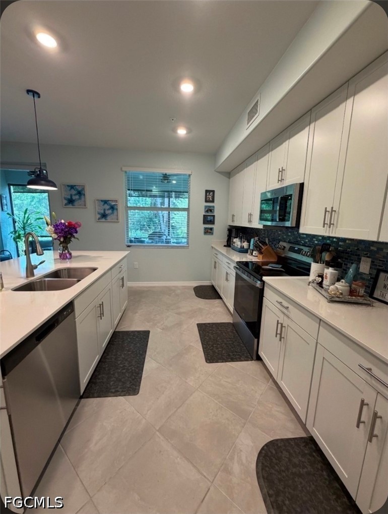 14191 Poppy Fld Loop, Unit 5312 Punta Gorda, FL 33955 - Photo 6 of 41 a kitchen with a sink stove and microwave