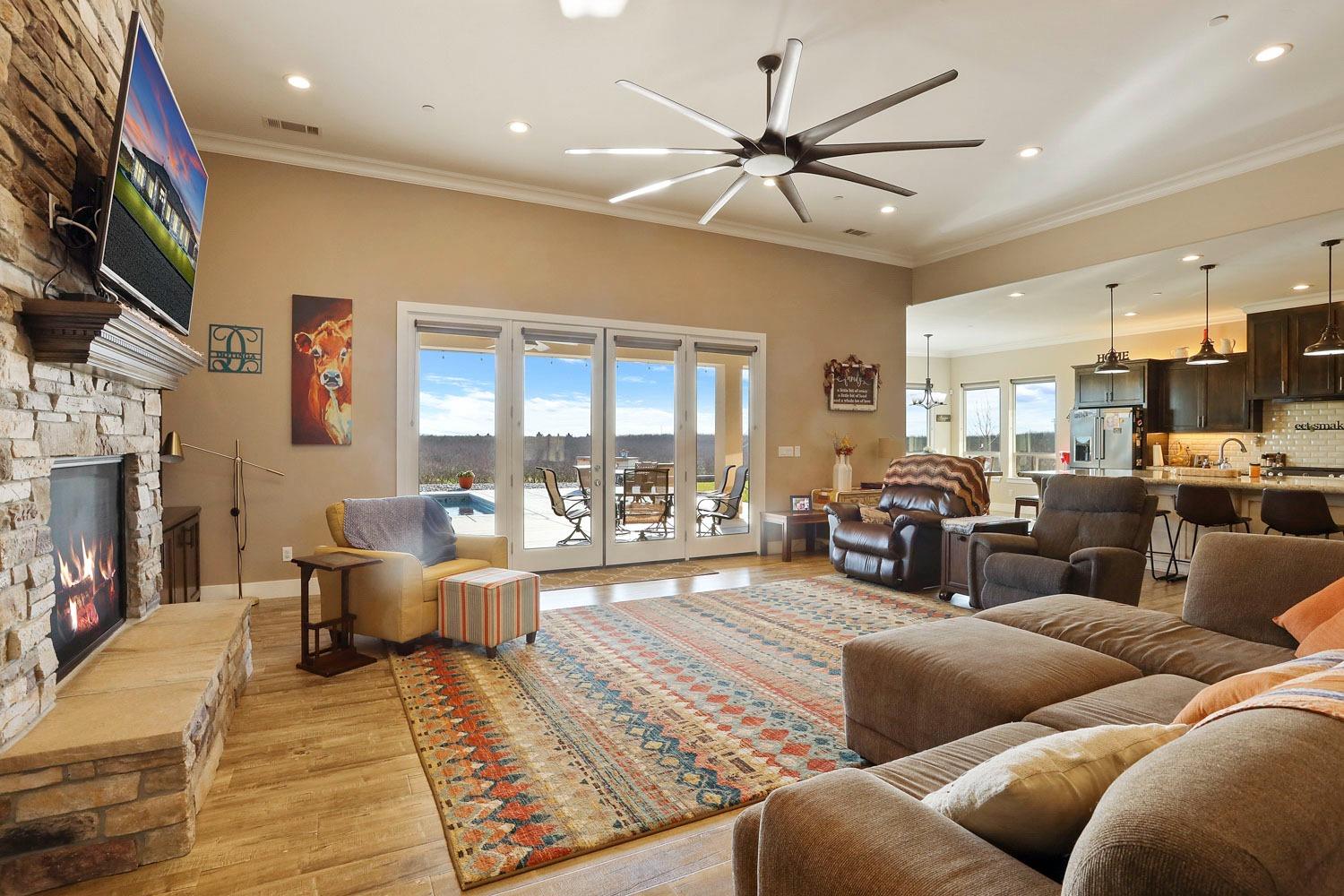 10393 Bradbury Road Ballico, CA 95303 - Photo 5 of 85 a living room with furniture kitchen view and a fireplace