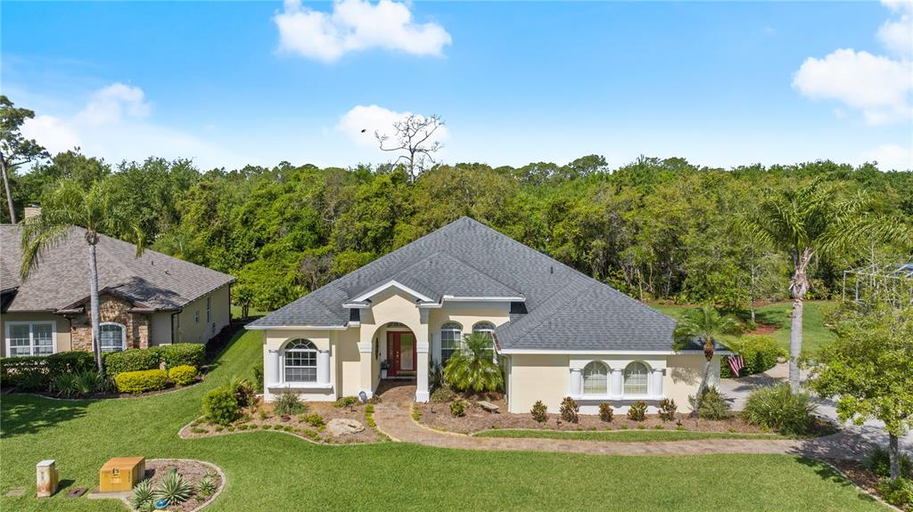 3428 Rexford Circle Ormond Beach, FL 32174 - Photo 1 of 1 a front view of a house with a garden