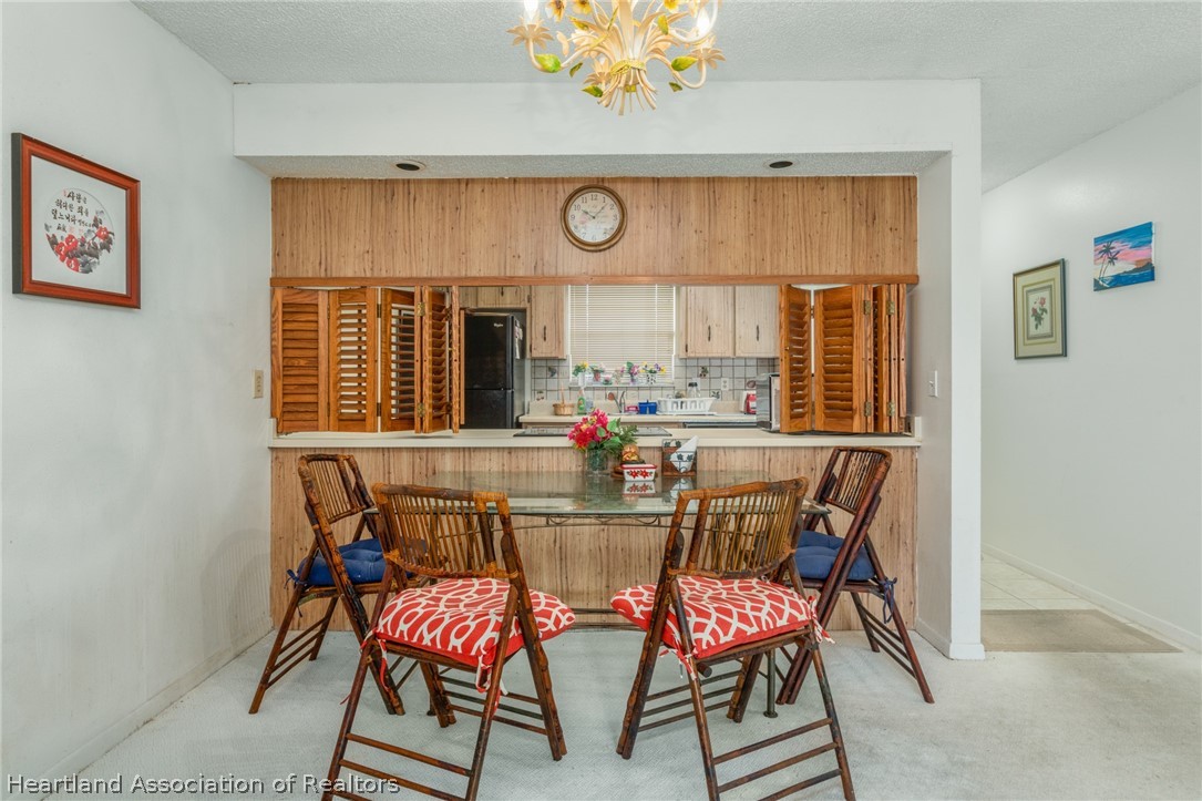 4722 Granada Boulevard Sebring, FL 33872 - Photo 4 of 11 a view of a dining room with furniture and window