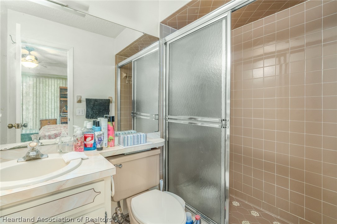 4722 Granada Boulevard Sebring, FL 33872 - Photo 9 of 11 a bathroom with a sink toilet vanity and shower