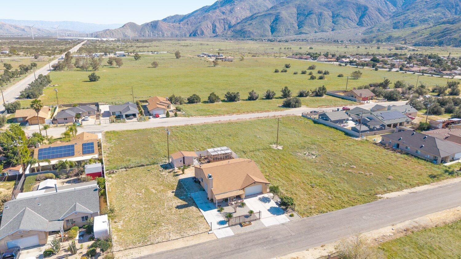 14280 Rafael Street Cabazon, CA 92230 - Photo 2 of 9 an aerial view of a city with houses