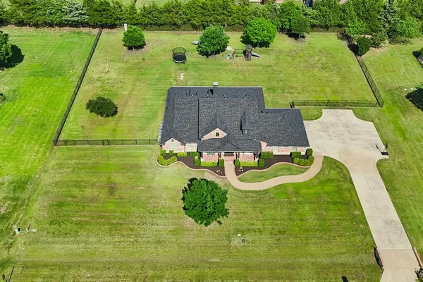a aerial view of a house with pool and a yard