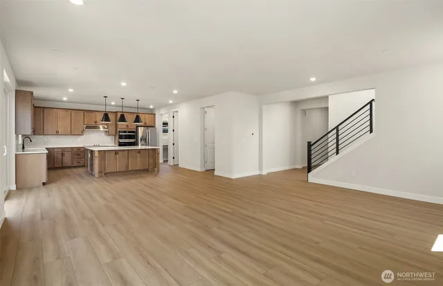 a view of kitchen with wooden floor and electronic appliances