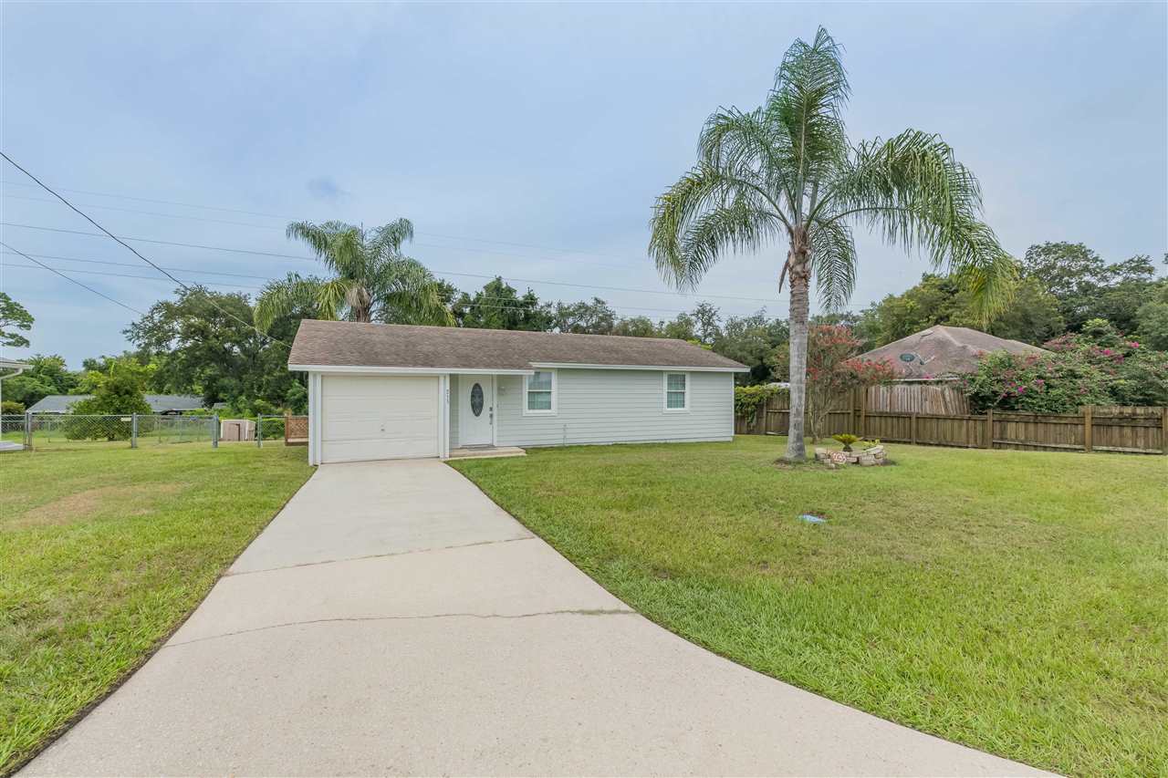 233 Cornell Road St. Augustine, FL 32086 - Photo 1 of 35 a front view of a house with a yard and palm trees