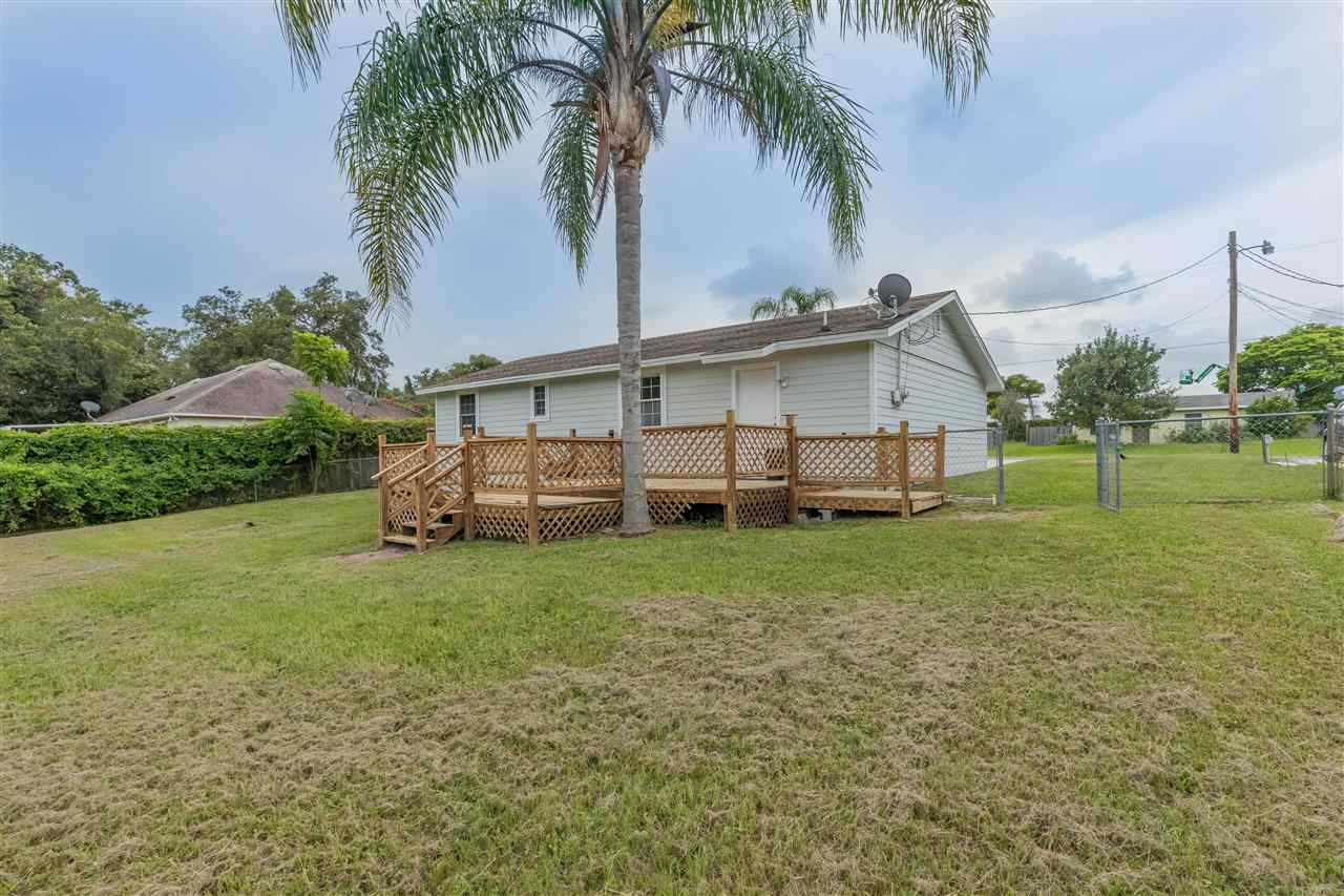 233 Cornell Road St. Augustine, FL 32086 - Photo 16 of 35 a view of a house with a yard and palm trees