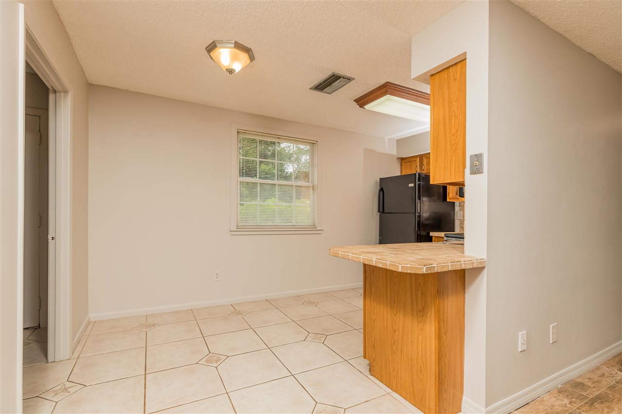 233 Cornell Road St. Augustine, FL 32086 - Photo 7 of 35 a view of washer and dryer with kitchen in the background