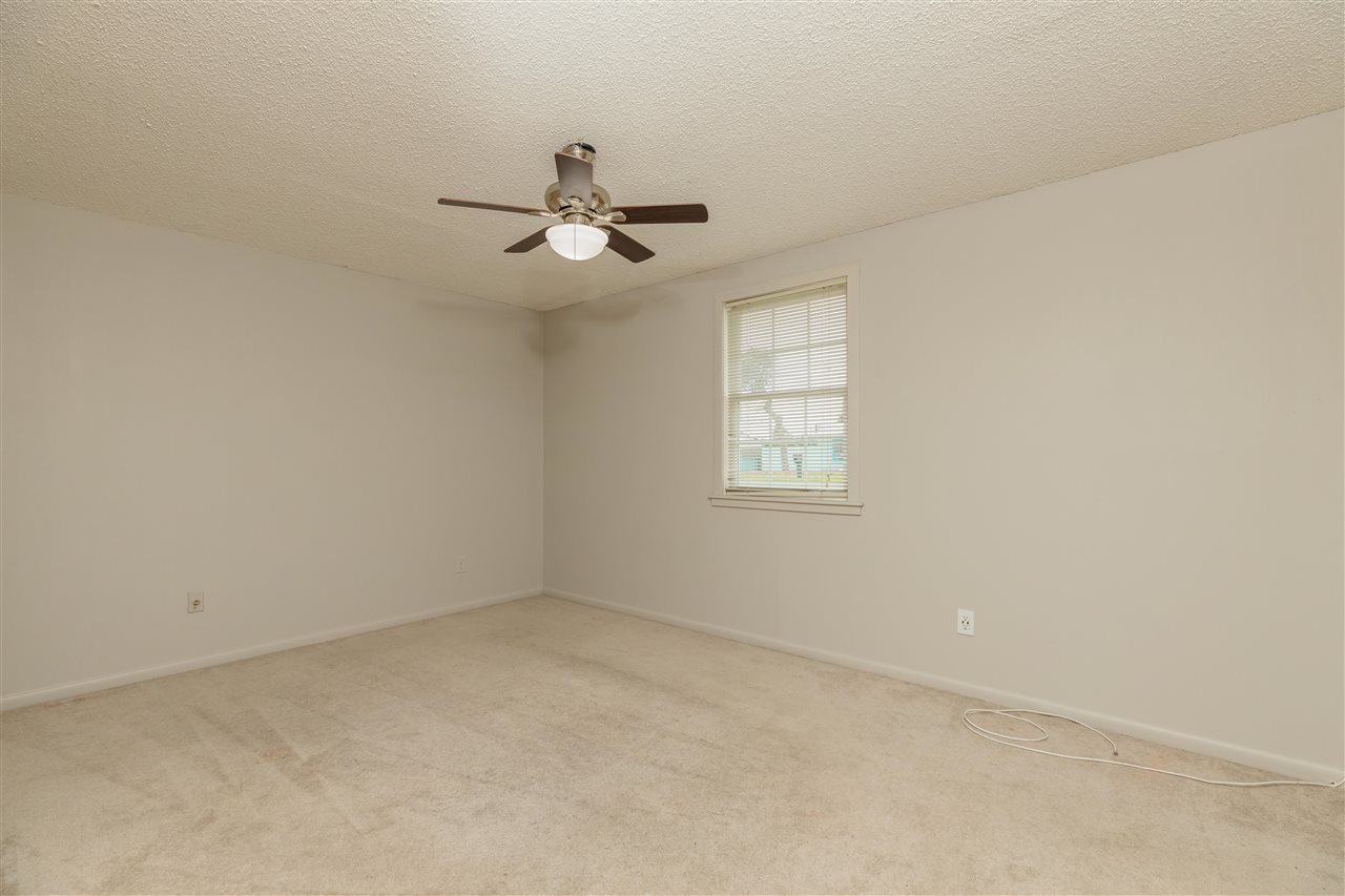 233 Cornell Road St. Augustine, FL 32086 - Photo 10 of 35 an empty room with windows and fan
