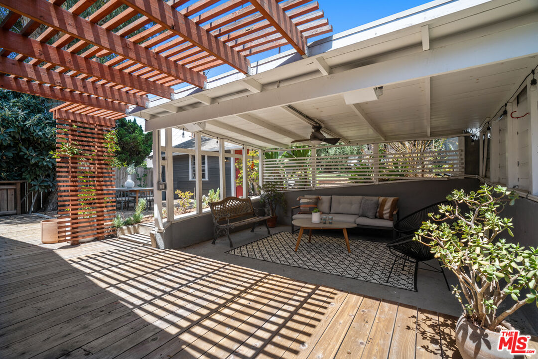 6157 Springvale Drive Los Angeles, CA 90042 - Photo 17 of 21 a view of a patio with table and chairs barbeque with wooden floor