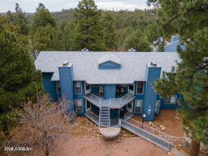 2700 South White Mountain Road, Unit 1126 Show Low, AZ 85901 - Photo 1 of 32 an aerial view of a house with a yard garage and a table
