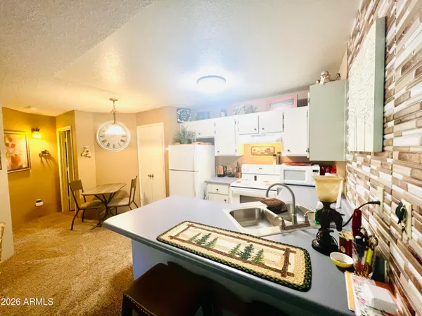 a kitchen with a refrigerator and a stove