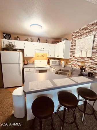a kitchen with a table chairs stove and sink