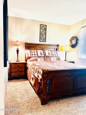 a bed sitting in a bedroom next to a window